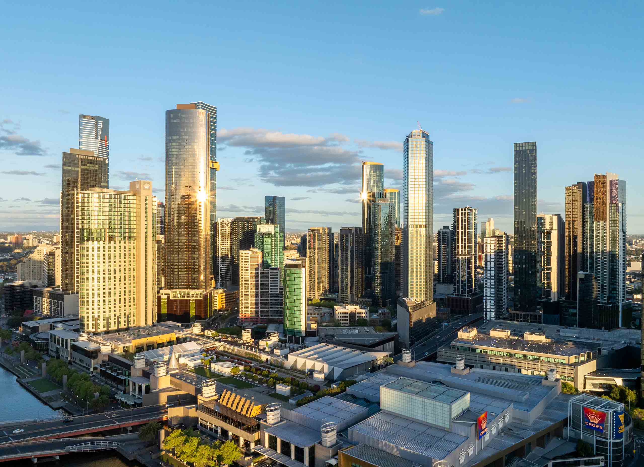 Melbourne Skyline Showcasing Evening Construction Progress Melbourne city skyline at dusk showing new high-rise developments, cranes, and landmark buildings.